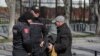 Moldovan police check a man's belongings during an anti-government protest in Chisinau on March 12. 