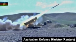 A multiple rocket launcher of the Azerbaijani armed forces fires during clashes over the breakaway region of Nagorno-Karabakh in an unknown location in Azerbaijan.