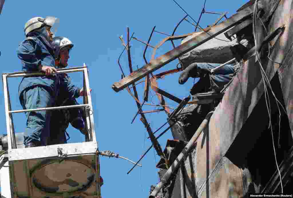 Workers use a crane to remove a body from a destroyed building on May 12. Thousands of civilians are believed to have died from the Russian onslaught, with many bodies still lying underneath the rubble.