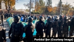 Police remove the tents set up by the Shor Party on the central boulevard in Chisinau on October 10.