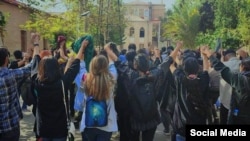 Female students of the art faculty at Tehran University protest without wearing the mandatory hijab on October 18.