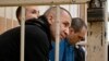 Three lawyers who represented late opposition leader Aleksei Navalny -- Igor Sergunin, Aleksei Liptser, and Vadim Kobzev appear in court in the town of Petushki in Russia's Vladimir region on September 12.