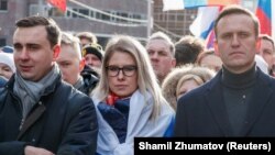 Russian opposition politicians Ivan Zhdanov (left to right), Lyubov Sobol, and Aleksei Navalny attend a rally in 2020 to mark the fifth anniversary of opposition politician Boris Nemtsov's assassination.