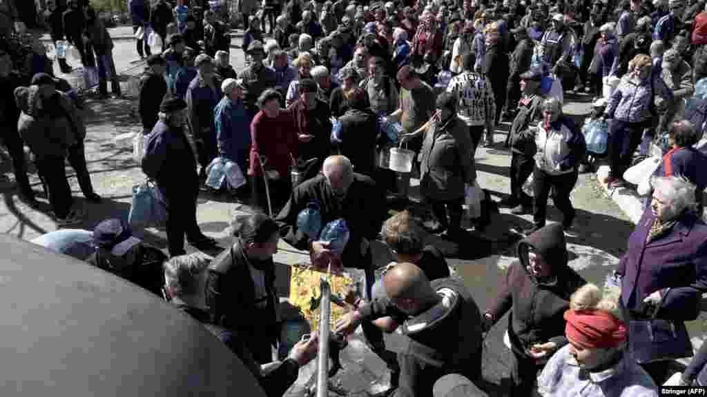 Mariupol residents queue for water on May 10.