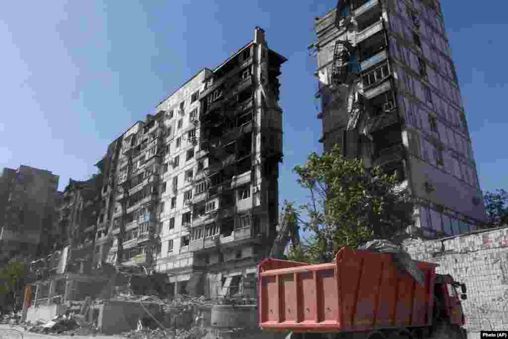 Workers clear rubble from a residential area on May 12.&nbsp;