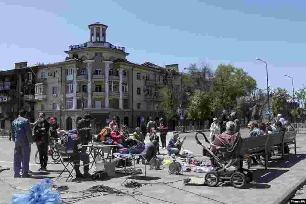 Local residents gather to charge their mobile phones with a generator provided by the local separatist authorities on May 12.&nbsp;