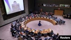 Ukrainian President Volodymyr Zelenskiy appears on a screen as he addresses the UN Security Council from Kyiv on April 5.