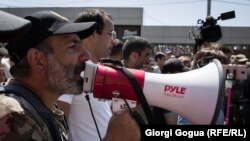 Armenian opposition leader Nikol Pashinian addresses supporters on the streets of Yerevan with a bullhorn on April 26.