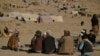 Afghan men sit at a camp for internally displaced persons in Qala-i-Naw, Badghis Province, in October.