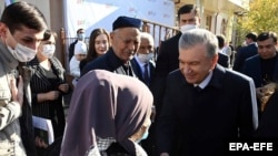 Uzbek President Shavkat Mirziyoev speaks with supporters at a polling station in Tashkent during the presidential election in October 2021.