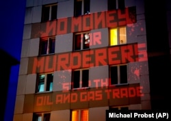 The words "No Money For Murderers, Stop The Oil And Gas Trade" are projected by activists onto the Russian Consulate in Frankfurt, Germany, on April 4.