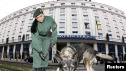 A police officer with a sniffer dog searches for explosives before the start of the Munich conference.