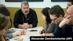 The move comes just four months after Novaya gazeta's editor in chief, Dmitry Muratov (center), was a co-winner of the 2021 Nobel Peace Prize for his "efforts to safeguard freedom of expression."