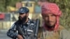 Taliban fighters man a checkpoint outside Kabul on October 3.