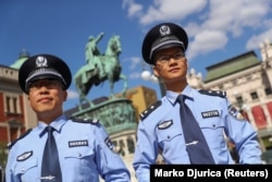 Chinese police officers stand on Belgrade's Republic Square during a joint patrol with Serbian police officers in 2019.