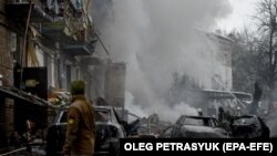 Firefighters work at the site of an apartment block destroyed by shelling in Vyshhorod, near Kyiv, on November 23.