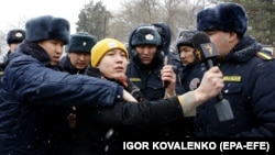 Police detain an RFE/RL journalist covering a protest near the government building in Bishkek in January.