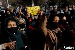 Afghan women chant slogans in protest against the closure of universities to women by the Taliban in Kabul in December.