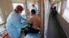 A man receives a dose of the Sputnik V vaccine in a carriage of a medical train at a railway station in the town of Tulun in the Irkutsk region on March 16. As of last week, less than 5 percent of the Russian population had been vaccinated.