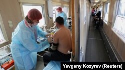 A man receives a dose of the Sputnik V vaccine in a carriage of a medical train at a railway station in the town of Tulun in the Irkutsk region on March 16. As of last week, less than 5 percent of the Russian population had been vaccinated.