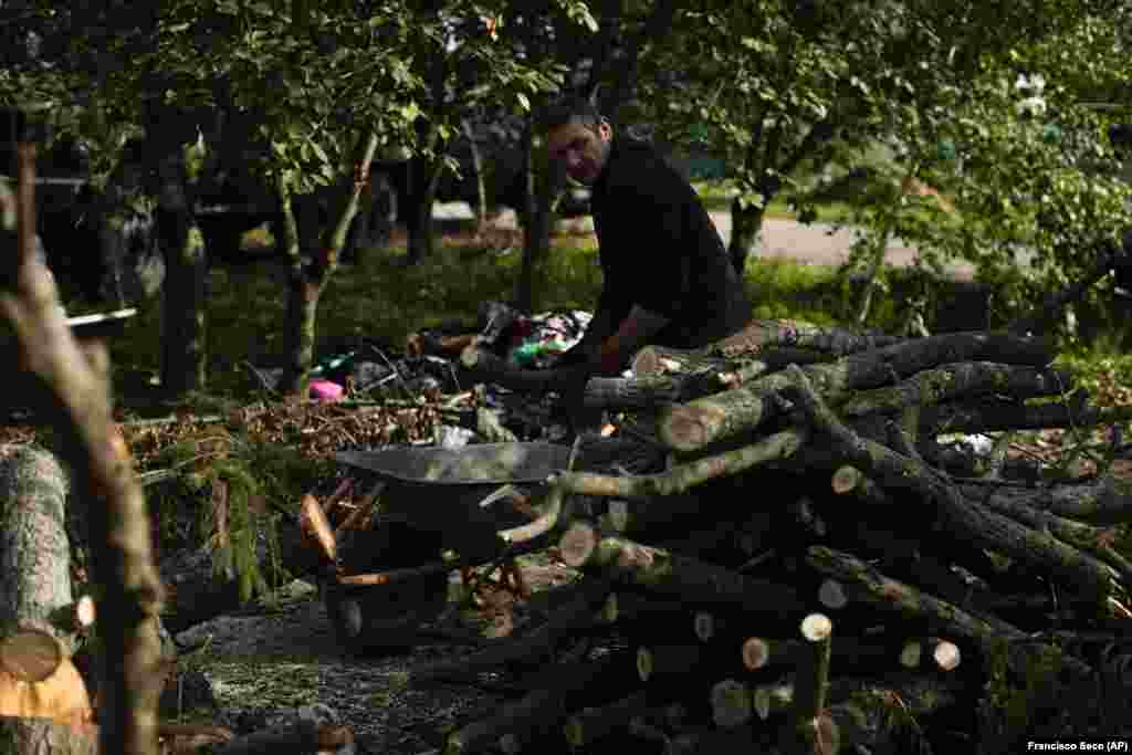 In the nearby village of Kyrylivka, Viktor Palyanitsa piles freshly cut logs in the yard of his house. Palyanitsa, 37, says he&#39;s gathered enough wood to last the entire winter. Still, he plans to begin sleeping beside a wood-burning stove in an outbuilding, since all of the windows in his house have been blown out by flying shrapnel. &nbsp;