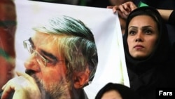 Supporters wave a poster of reformist candidate Mir Hossein Musavi. 'Yas No' had thrown its weight behind the candidate.