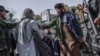 Taliban members attempt to stop women from protesting for their rights in Kabul.