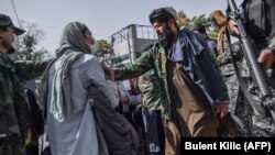 Taliban members attempt to stop women from protesting for their rights in Kabul.