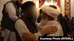 Acting Interior Minister Sirajuddin Haqqani purportedly seen greeting families of suicide attackers during an event in Kabul in October 2021.