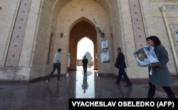 A member of a local election commission walks with a mobile ballot box as she visits voters at their homes during Uzbekistan's presidential election in Tashkent on October 24, 2021.