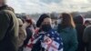 A pro-Saakashvili protester in Tbilisi draped in a U.S. flag (file photo)