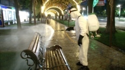 A worker sprays disinfectant in Khujand on April 28.