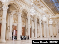 Tourists are shown one of the massive rooms in Bucharest's parliament building on January 12.