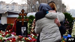 Mourners react by the grave of Russian opposition leader Aleksei Navalny at a Moscow cemetery on March 2. 