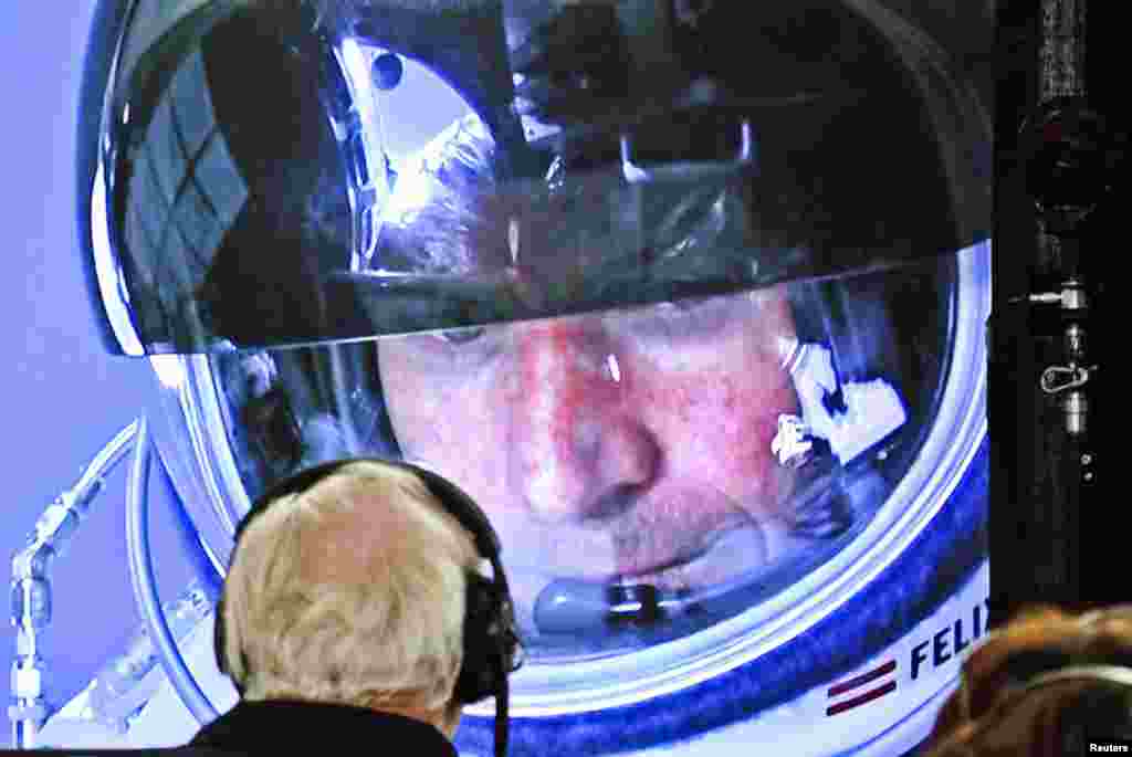 Baumgartner is seen inside the capsule on a screen at mission control during the final moments of the ascent.