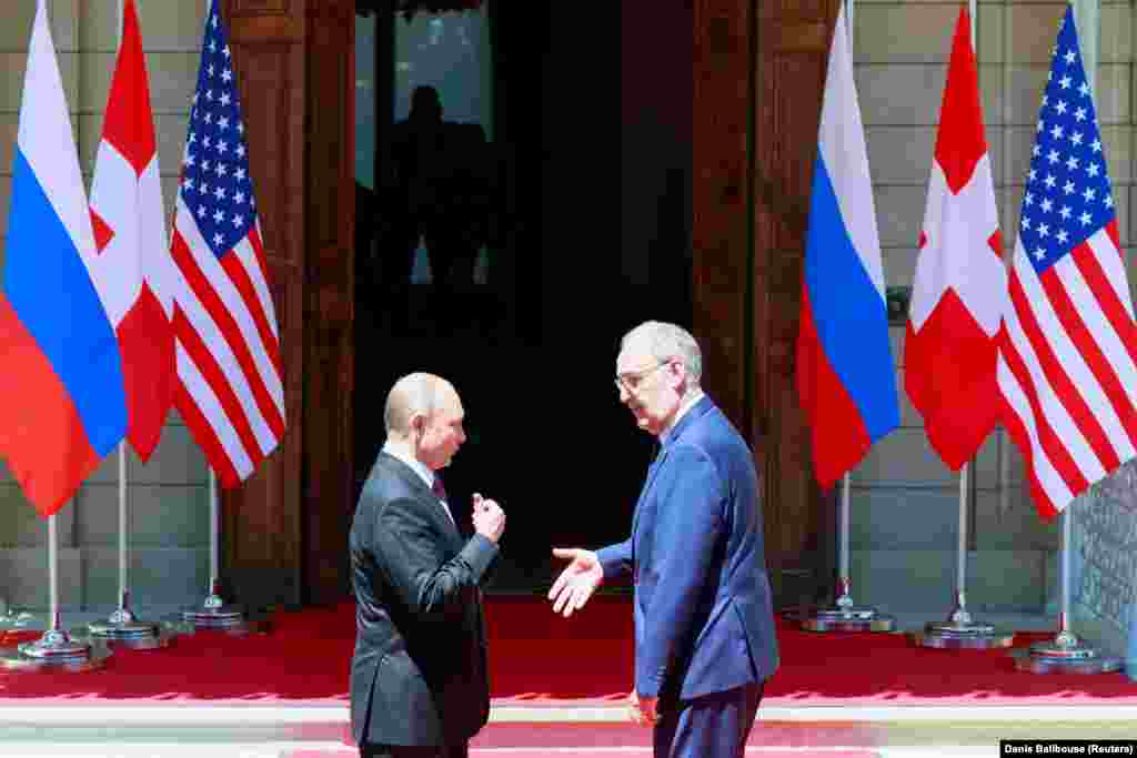 Swiss President Guy Parmelin greets Russia&#39;s President Vladimir Putin before he enters the villa.&nbsp;