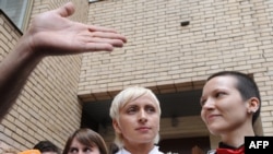 Irina Shapitko (right) and Irina Fedotova-Fet exit a wedding registration office in Moscow on May 12.