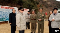 North Korean leader Kim Jong-il (in sunglasses) inspecting a power station's construction site on March 26.