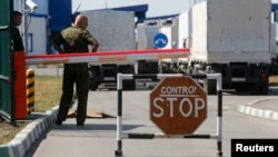 A Russian convoy of trucks that Moscow claimed were carrying humanitarian aid -- but which entered Ukraine without being searched or cleared by neutral observers -- stand at the "Donetsk" Russia-Ukraine border crossing in August.