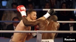 Afghan-German boxer Hamid Rahimi trades punches with his Tanzanian opponent, Said Mbelwa, in their WBO title bout in Kabul on October 30.