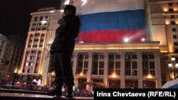 A police officer patrols next to a pro-Putin meeting on Manezh Square in Moscow on March 4.