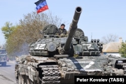 A Russian serviceman is seen on a T-72 tank in the village of Bezimenne that came under control of pro-Russian forces earlier this month.