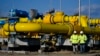 Workers walk onsite at a gas metering station of a pipeline link between Bulgaria and Greece near the village of Malko Kadievo, Bulgaria. 