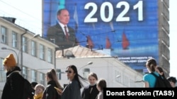 An electronic screen, installed on the facade of a building in Yekaterinburg, shows Russian President Vladimir Putin as he delivers his annual address on April 21. 