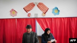 Voters prepare to cast ballots in Gratia, near Bucharest, in Romania's December 6 runoff vote.