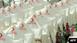 Homeless survivors of a major earthquake in the eastern province of Van take shelter at the Turkish Red Crescent tent camp in Ercis.