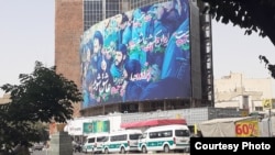 Police cars wait to arrest women not wearing Islamic hijab in Tehran on July 6.