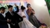 The 30-second video, which has swept across websites and media outlets around the world, shows the bridegroom suddenly hitting the bride after she completed a game to open candy before him. (video grab)