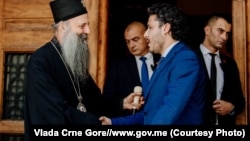 The head of the Serbian Orthodox Church, Patriarch Porfirije (left), and Montenegrin Prime Minister Dritan Abazovic meet in June.