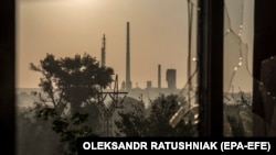 The Azot chemical plant is seen through a broken window in the city of Syevyerodonetsk on June 19.